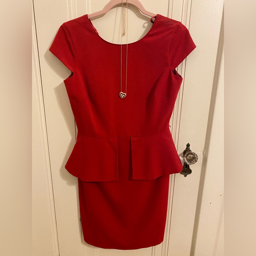 Flattering red dress with peplum detailing around the side